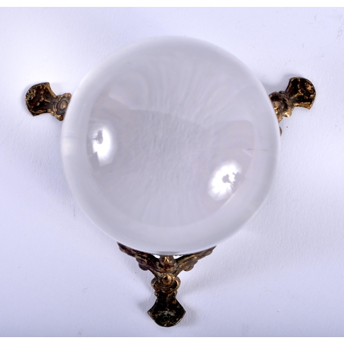 584 - AN ANTIQUE CRYSTAL BALL upon a gilt metal base. 5.25cm wide.