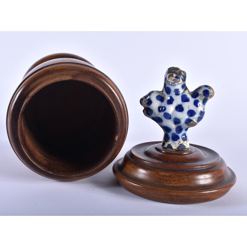 585 - AN 18TH/19TH CENTURY CARVED TREEN VASE AND COVER with 18th century Delft pottery finial. 24 cm high.