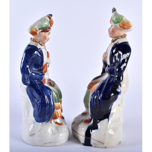 588 - A PAIR OF ANTIQUE STAFFORDSHIRE POTTERY FIGURES OF TURKS. 19 cm high.