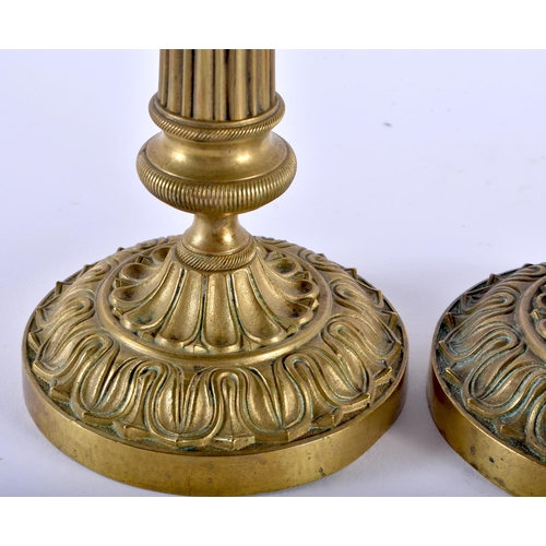 590 - A PAIR OF 19TH CENTURY FRENCH EMPIRE STYLE BRONZE CANDLESTICKS overlaid with acanthus. 27 cm high.