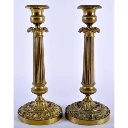 590 - A PAIR OF 19TH CENTURY FRENCH EMPIRE STYLE BRONZE CANDLESTICKS overlaid with acanthus. 27 cm high.