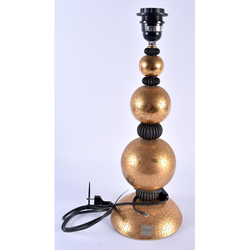 594 - A STYLISH GILT CERAMIC DRIMMER LAMP. 44 cm high.