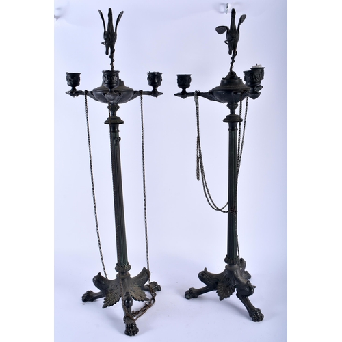 597 - A LARGE PAIR OF EARLY 19TH CENTURY FRENCH BRONZE CANDLESTICKS After the Antiquity. 62 cm high.