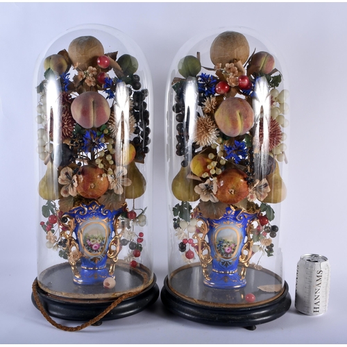 600 - A LARGE PAIR OF 19TH CENTURY FRENCH PORCELAIN FAUX FRUIT SCULPTURES with glass domes. 54 cm high.