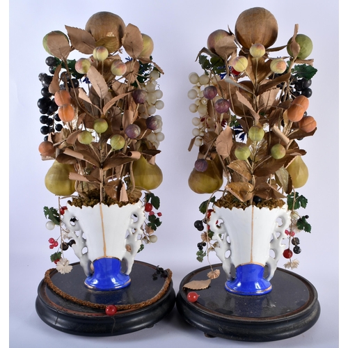 600 - A LARGE PAIR OF 19TH CENTURY FRENCH PORCELAIN FAUX FRUIT SCULPTURES with glass domes. 54 cm high.