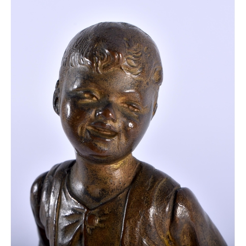 618 - AN ART DECO SPELTER FIGURE OF A BOY. 20 cm high.