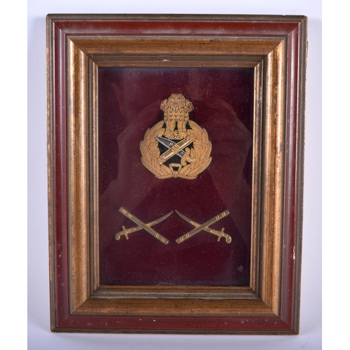 619 - A FRAMED MILITARY BADGE. 24 cm x 18 cm.