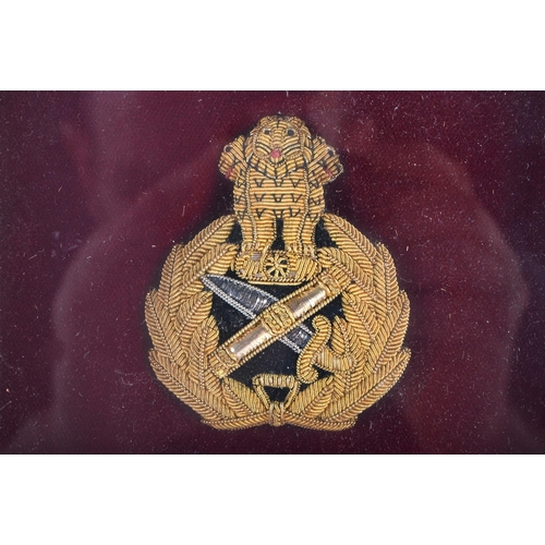 619 - A FRAMED MILITARY BADGE. 24 cm x 18 cm.