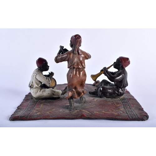 621 - A CONTINENTAL COLD PAINTED BRONZE FIGURAL GROUP modelled as three figures upon a rug. 15 cm square.