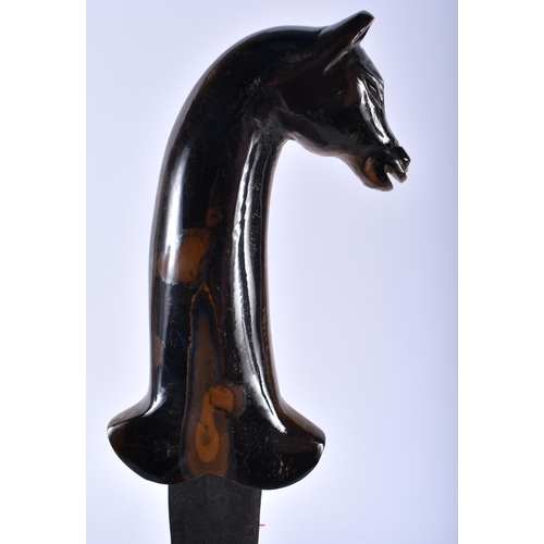 623 - A MIDDLE EASTERN CARVED TIGERS EYE HORSE HEAD HANDLED NIELLO DAGGER. 35 cm long.