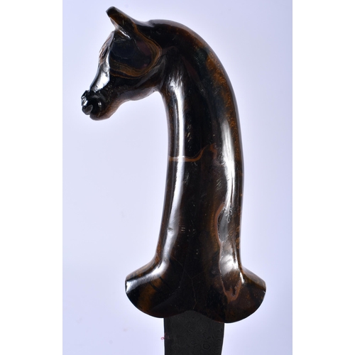 623 - A MIDDLE EASTERN CARVED TIGERS EYE HORSE HEAD HANDLED NIELLO DAGGER. 35 cm long.