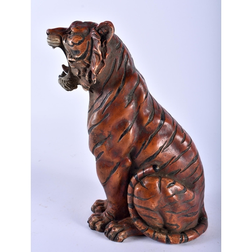 628 - A CONTINENTAL COLD PAINTED BRONZE FIGURE OF A SEATED TIGER modelled scowling. 22cm high.