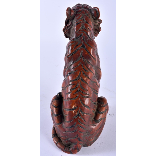 628 - A CONTINENTAL COLD PAINTED BRONZE FIGURE OF A SEATED TIGER modelled scowling. 22cm high.