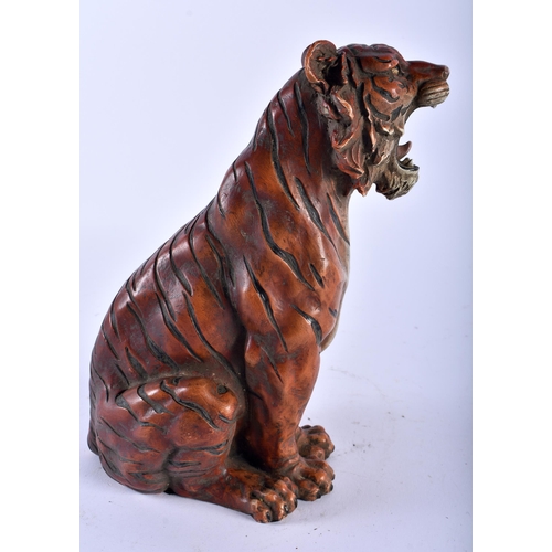 628 - A CONTINENTAL COLD PAINTED BRONZE FIGURE OF A SEATED TIGER modelled scowling. 22cm high.