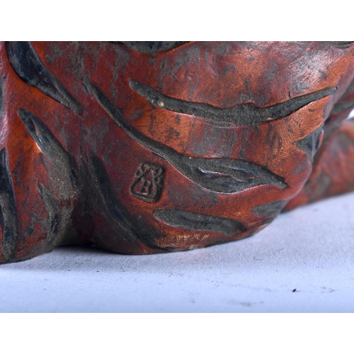 628 - A CONTINENTAL COLD PAINTED BRONZE FIGURE OF A SEATED TIGER modelled scowling. 22cm high.