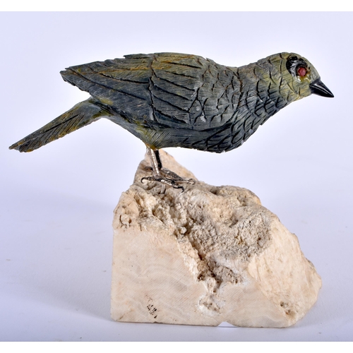 633 - A CONTINENTAL CARVED HARDSTONE BIRD with silver feet. 11 cm x 11 cm.