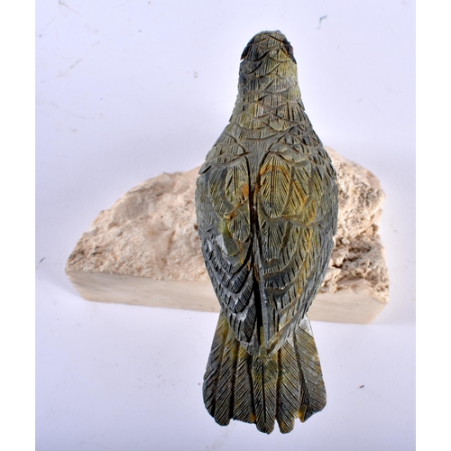 633 - A CONTINENTAL CARVED HARDSTONE BIRD with silver feet. 11 cm x 11 cm.