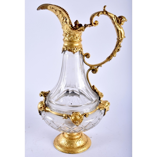 650 - AN ANTIQUE GILT MOUNTED GLASS CLARET JUG. 35 cm high.