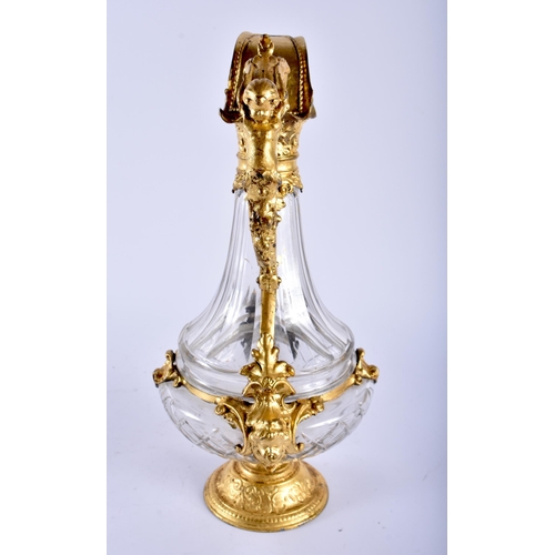 650 - AN ANTIQUE GILT MOUNTED GLASS CLARET JUG. 35 cm high.