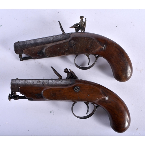 653 - A PAIR OF ANTIQUE IRISH PISTOLS by Harris of Clonmel. 19 cm long.