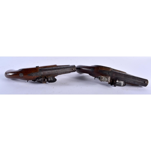 653 - A PAIR OF ANTIQUE IRISH PISTOLS by Harris of Clonmel. 19 cm long.