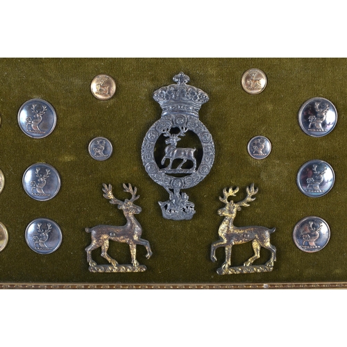 666 - A FRAMED COLLECTION OF ANTIQUE MILITARY BUTTONS. 42 cm x 18 cm.