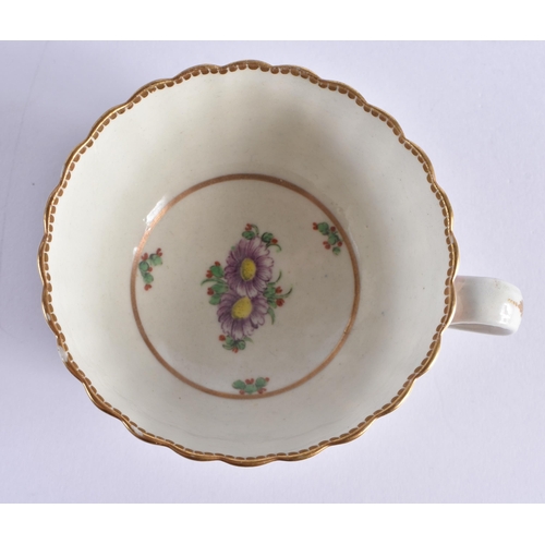 68 - AN 18TH CENTURY WORCESTER PORCELAIN FLUTED TEACUP AND SAUCER painted with puce trailing flowers unde... 