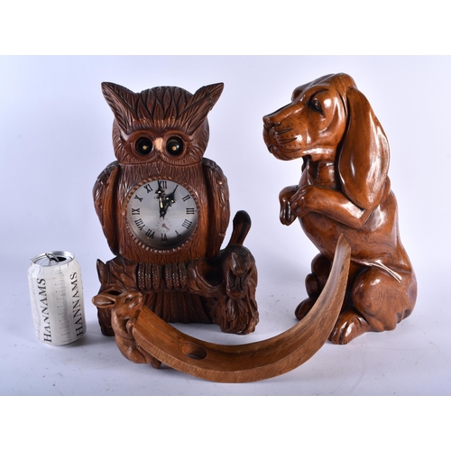 684 - A BAVARIAN BLACK FOREST OWL CLOCK together with a large wood begging hound & a rabbit mounted bottle... 