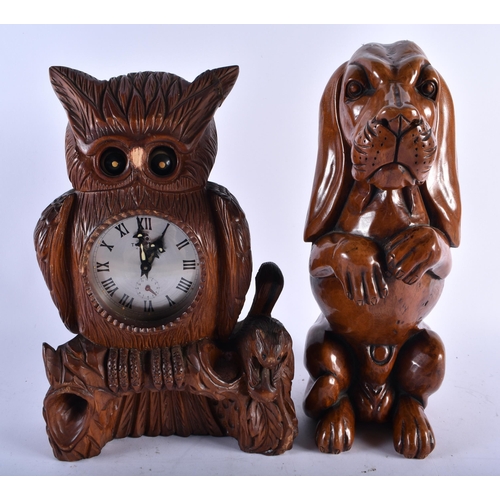 684 - A BAVARIAN BLACK FOREST OWL CLOCK together with a large wood begging hound & a rabbit mounted bottle... 