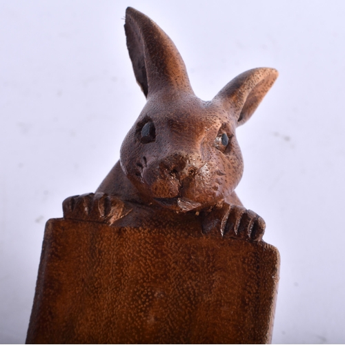 684 - A BAVARIAN BLACK FOREST OWL CLOCK together with a large wood begging hound & a rabbit mounted bottle... 