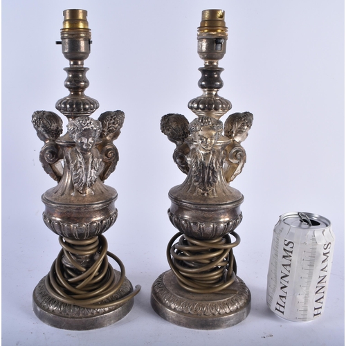 692 - A PAIR OF ANTIQUE CONTINENTAL SILVER PLATED LAMPS. 23.5 cm high.