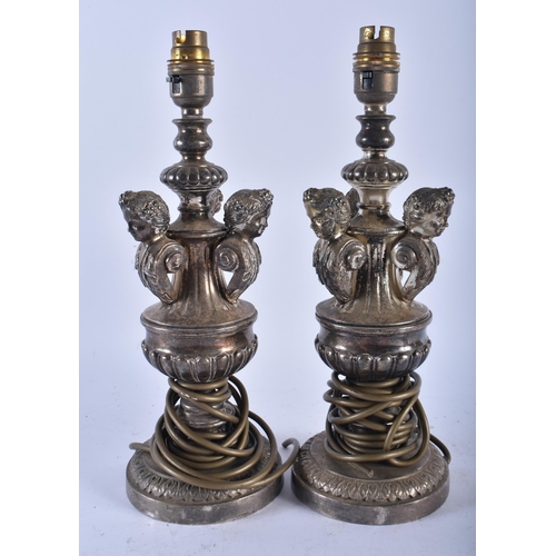 692 - A PAIR OF ANTIQUE CONTINENTAL SILVER PLATED LAMPS. 23.5 cm high.