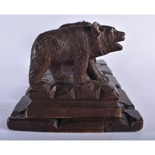 731 - AN ANTIQUE BAVARIAN BLACK FOREST EXTENDING BEAR BOOKENDS. 48cm wide extended.