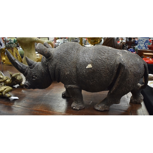 764 - A VERY LARGE AND EXTREMELY HEAVY AFRICAN CARVED JADE TYPE STONE RHINOCEROS. 75 cm x 38 cm.