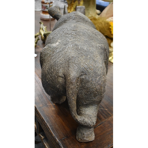 764 - A VERY LARGE AND EXTREMELY HEAVY AFRICAN CARVED JADE TYPE STONE RHINOCEROS. 75 cm x 38 cm.