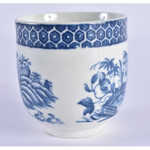 92 - A RARE 18TH CENTURY WORCESTER BLUE AND WHITE PORCELAIN COFFEE CUP decorated with flowering rock unde... 