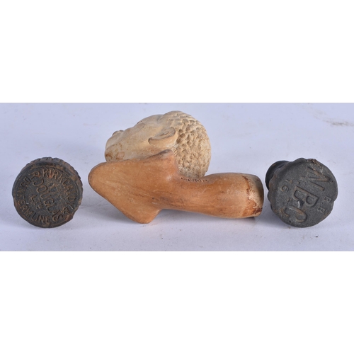 1035 - AN UNUSUAL ANTIQUE CHARLES CROP LONDON POTTERY PIPE together with two early bottle tops. Largest 7.5... 