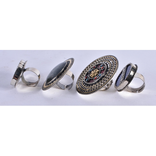 1044 - FOUR MIDDLE EASTERN RINGS. 78.4 grams. Largest 5.5 cm wide. (4)