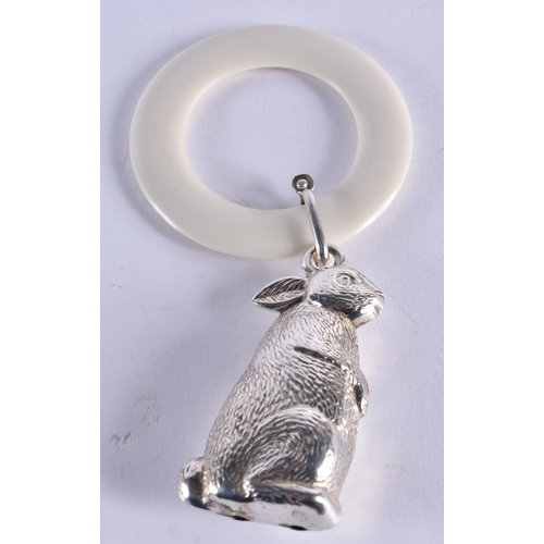 1048 - AN ANTIQUE SILVER HAMMERED SILVER TEETHING RING together with a white metal rabbit ring. London 1912... 