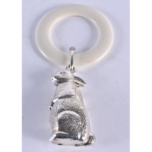 1048 - AN ANTIQUE SILVER HAMMERED SILVER TEETHING RING together with a white metal rabbit ring. London 1912... 