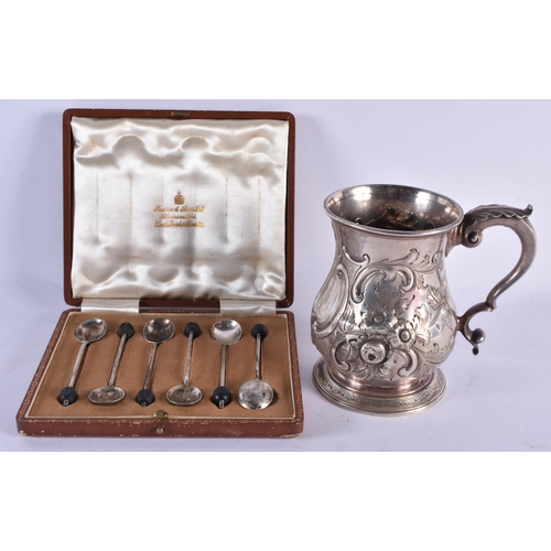 1063 - A VICTORIAN SILVER REPOUSSE MUG together with silver spoons. Mug London 1862. 310 grams. Largest 13 ... 