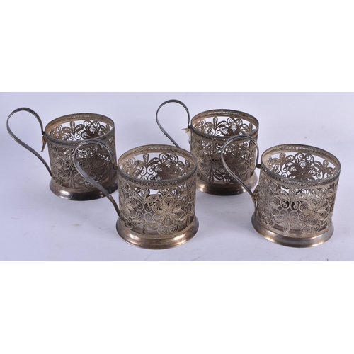 1065 - FOUR VINTAGE RUSSIAN WHITE METAL FILIGREE CUP HOLDERS. 405 grams. 6.5 cm x 7.75 cm. (4)