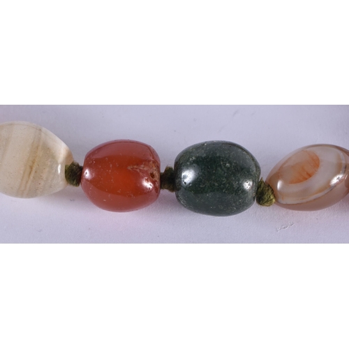 1071 - AN AGATE NECKLACE. 101 grams. 68 cm long.