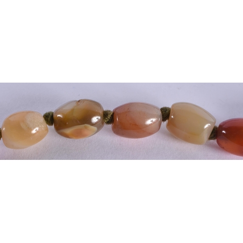 1071 - AN AGATE NECKLACE. 101 grams. 68 cm long.