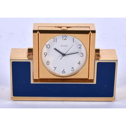 1121 - A WAKO ENAMELLED CLOCK. 237 grams. 6.25cm x 4.5 cm.