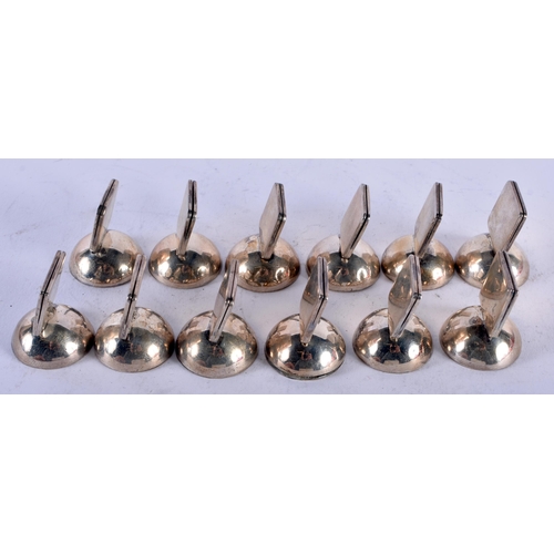 1134 - A SET OF TWELVE SILVER MENU HOLDERS. 579 grams. 3 cm x 2.5 cm. (12)