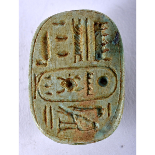 1159 - AN EGYPTIAN FAIENCE SCARAB BEETLE AMULET. 13 grams. 3 cm x 2 cm.