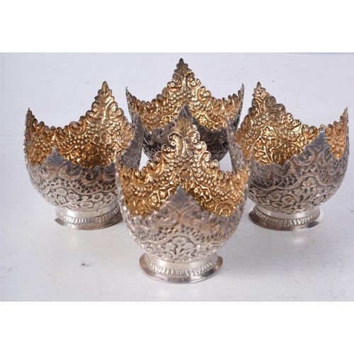 1235 - A LOVELY SET OF FOUR 19TH CENTURY INDIAN SILVER SALTS decorated with foliage. 162.5 grams. 7.75 cm x... 