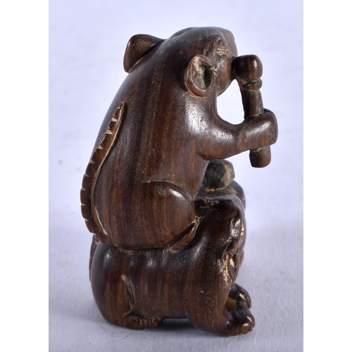 1264 - A Carved Hardwood Netsuke in the form of a Rat Banging a Drum on its back. 4.2cm x 3.2cm x 3.5cm, we... 