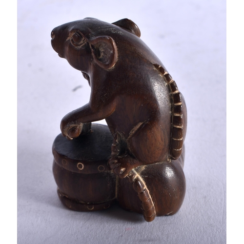 1264 - A Carved Hardwood Netsuke in the form of a Rat Banging a Drum on its back. 4.2cm x 3.2cm x 3.5cm, we... 